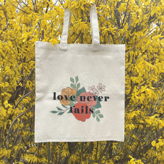 LOVE NEVER FAILS TOTE